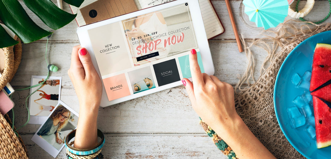 Photo of a woman which holds in arms a tablet and shopping online