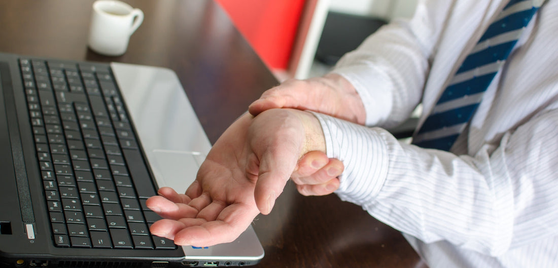 Photo of a businessman holding painful wrist